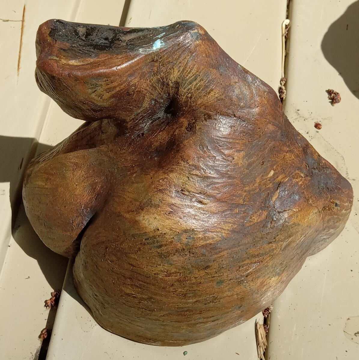 Shoulder study Ceramic sculptural study (a maquette) of a person's shoulder, neck and breast by Shane Brodie. The sculptor's fingermarks are seen on the surface which is mostly dark brown with a mix of lighter colors.