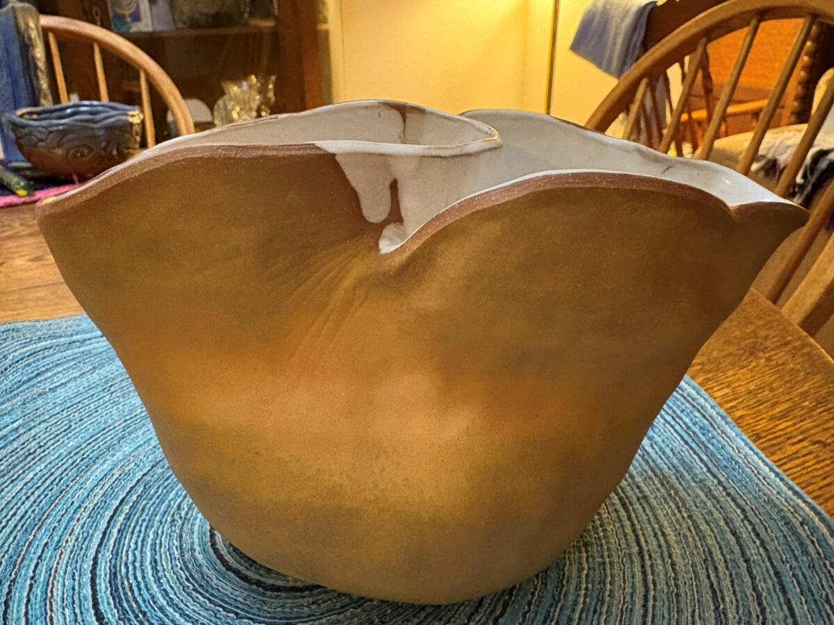 Flared vase Large vase with two widely flared openings with wavy rims by Shane Brodie. The yellowish stoneware clays are left unglazed on the exterior and the interior is glazed with a white liner. Between the flared openings, there are surface striations
